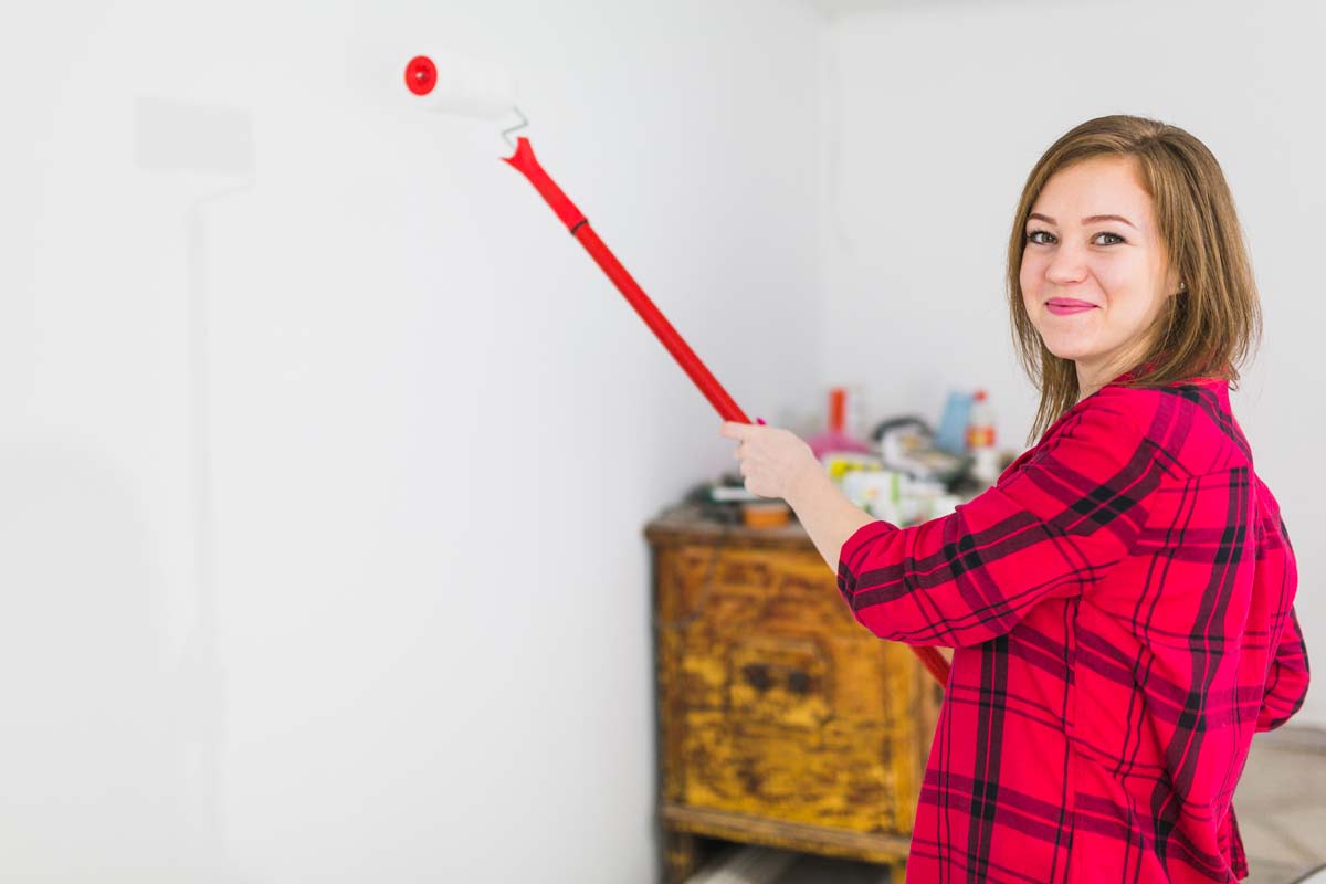 girl trying to paint walls