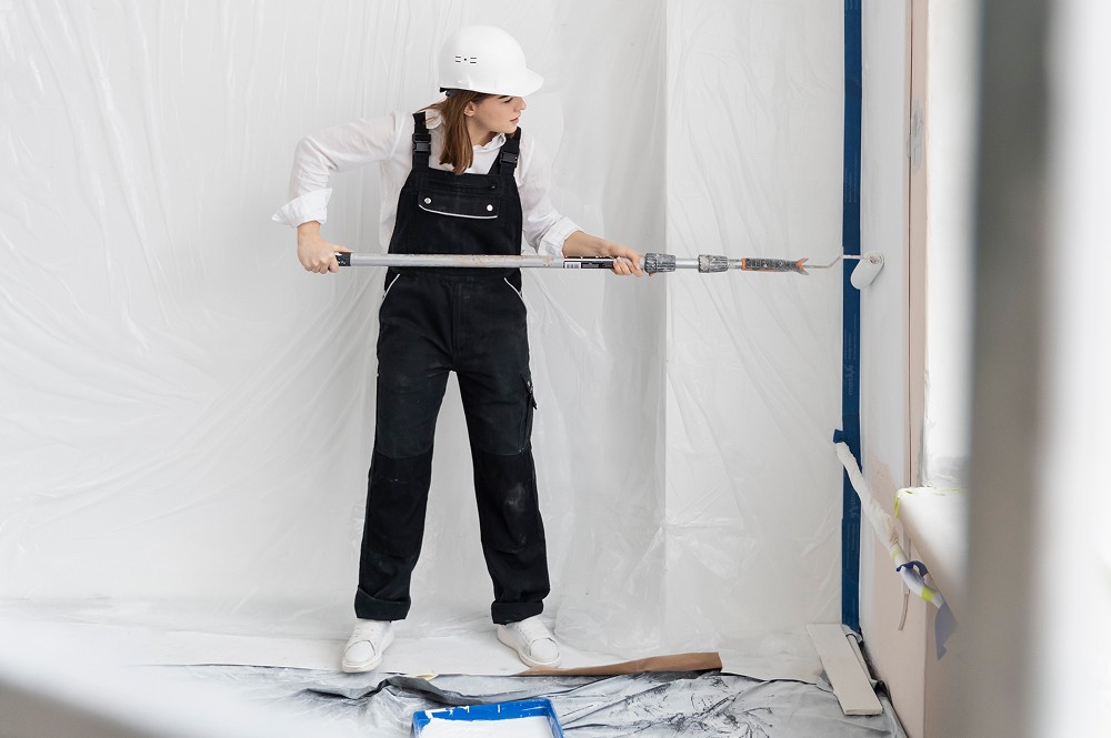 A woman painting walls