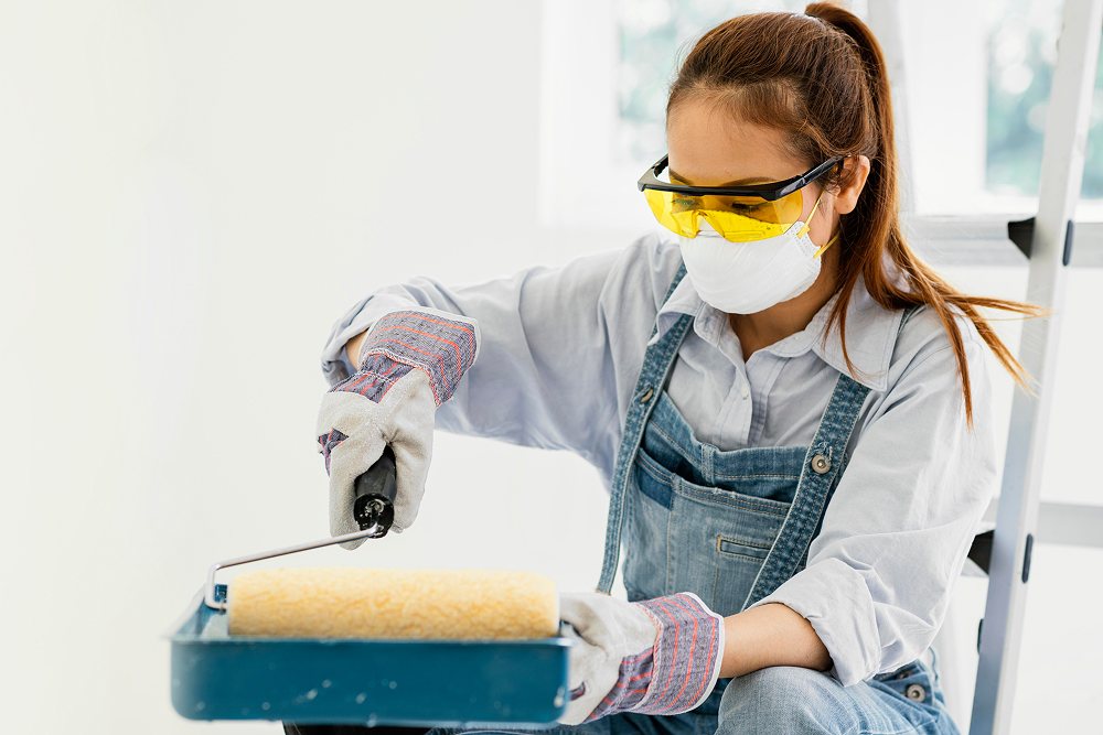 A woman with safety protection while painting