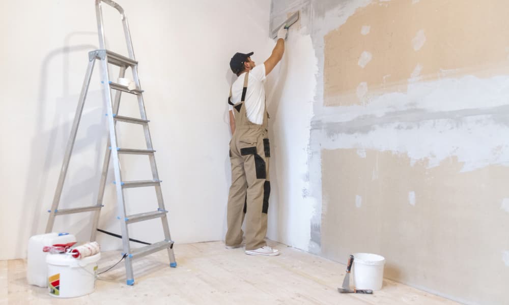 Painter applying wall primer