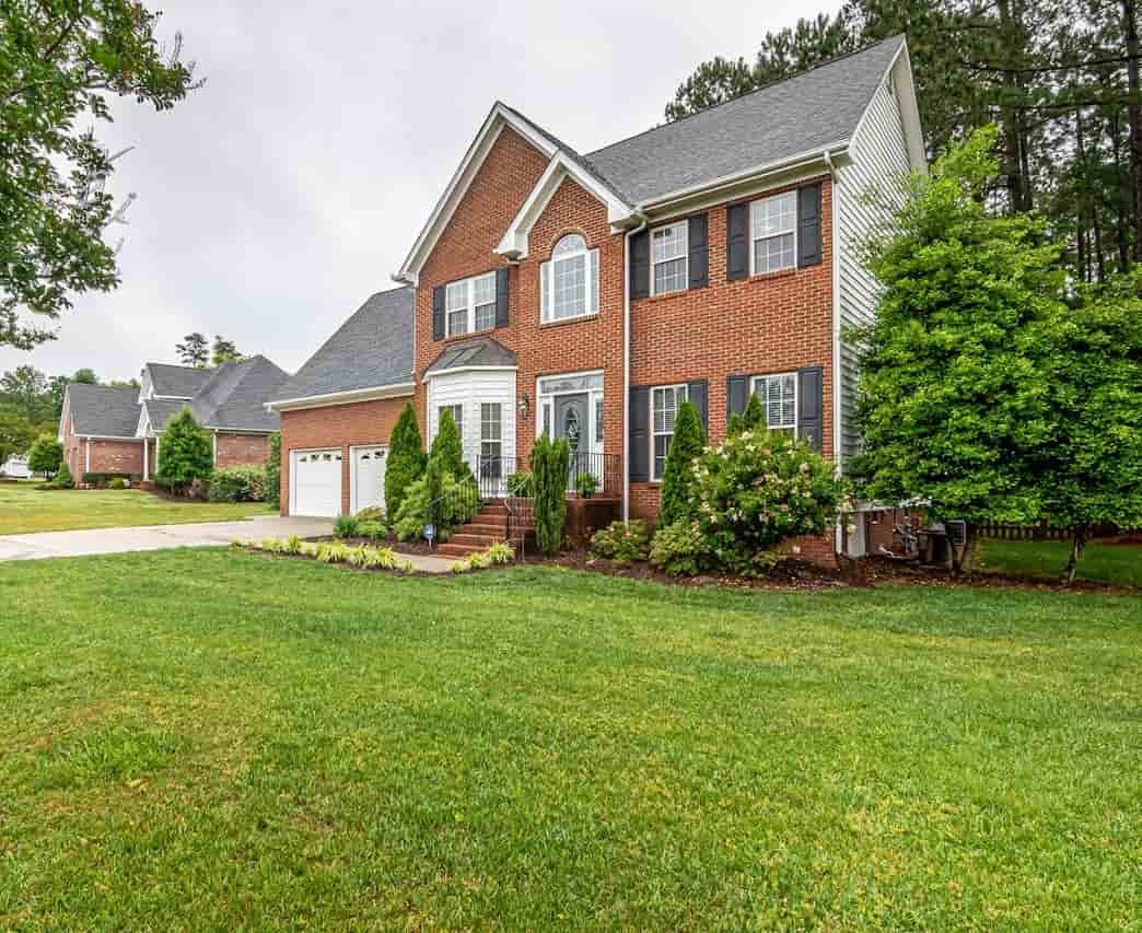 Exterior view of a two-story red brick suburban house