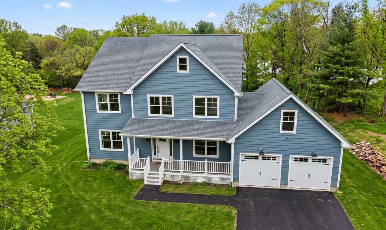 Aerial view of a two-story home featuring blue horizontal lap siding