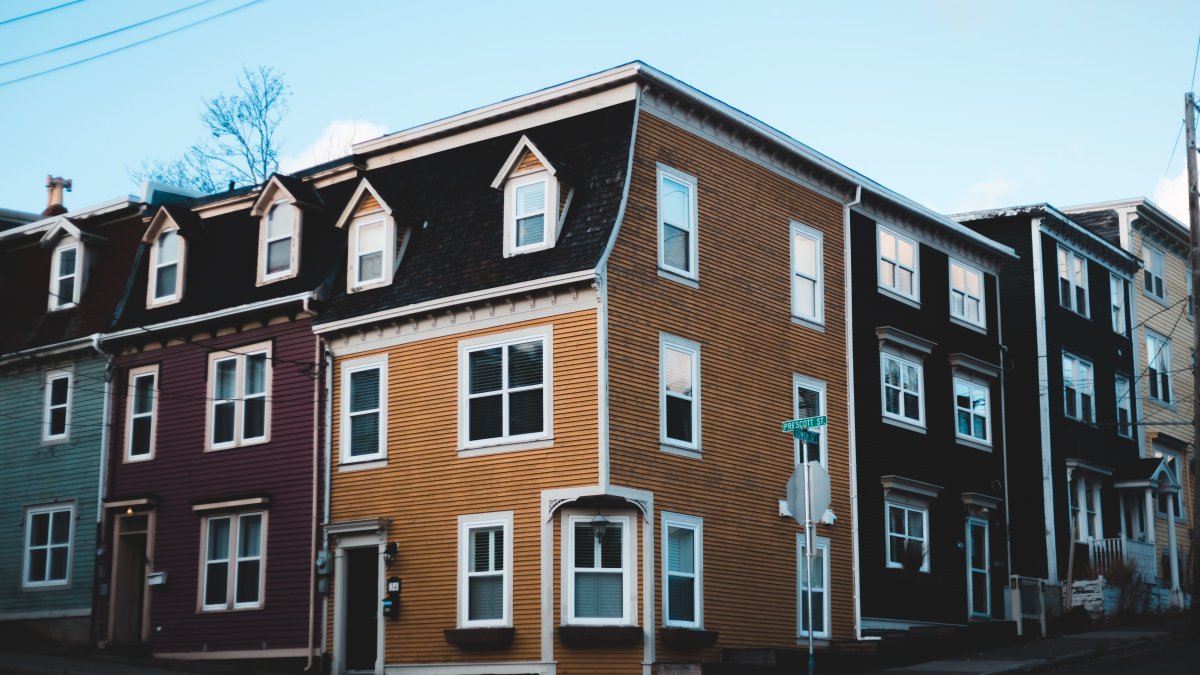 Row houses with colorful, well-maintained facades that illustrate quality exterior paint suited for diverse weather conditions.