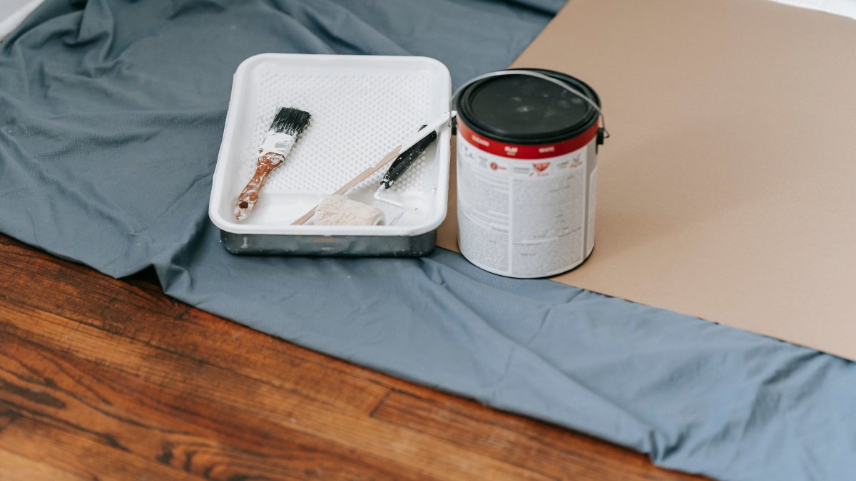 Painting tools and materials arranged indoors for a home renovation project.